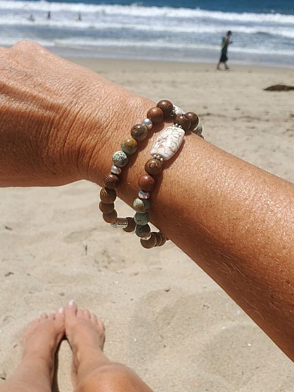 at the beach wearing an essential bracelet